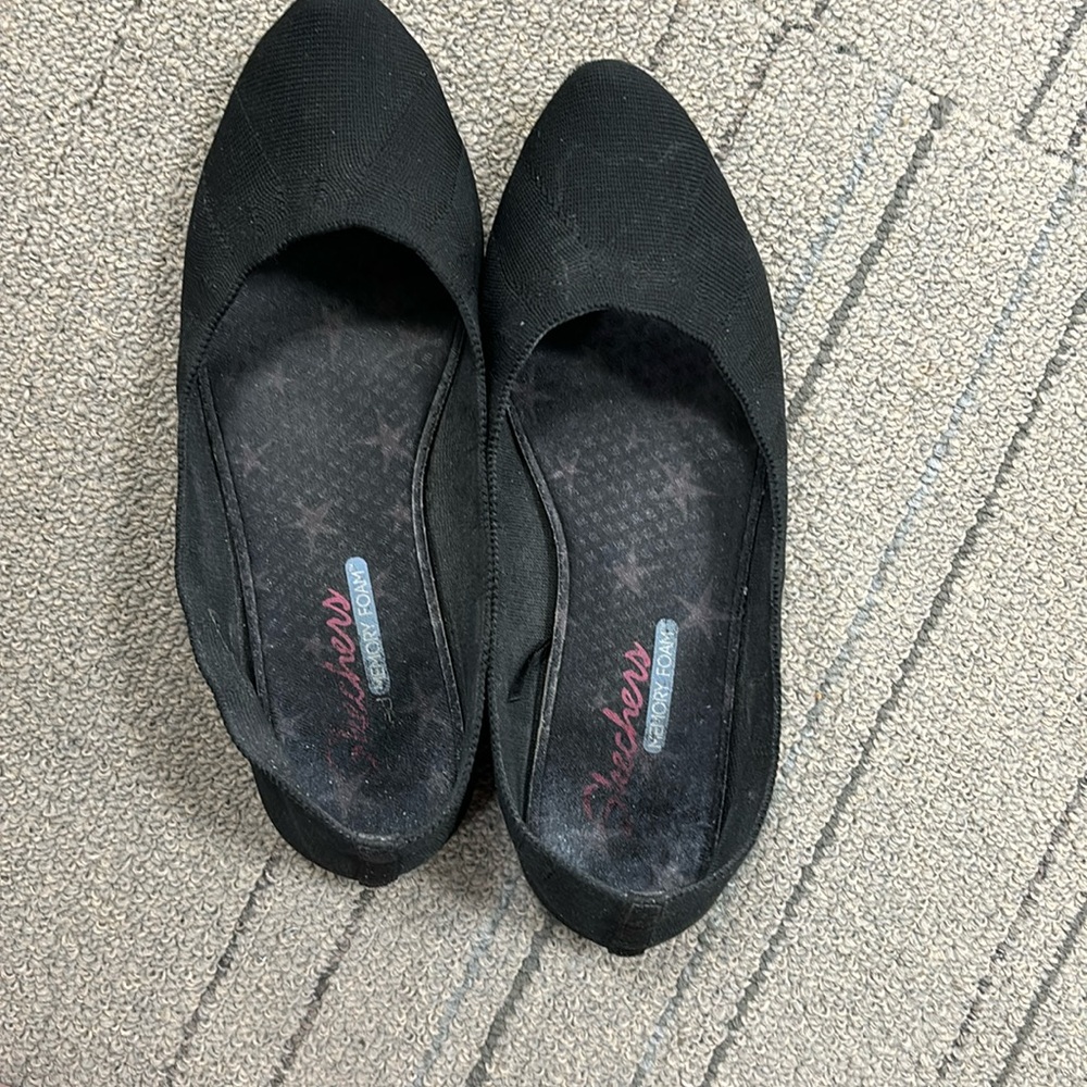 Worn out sketchers memory foam flats